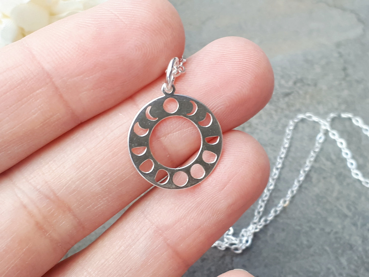 Moon phase necklace in sterling silver.