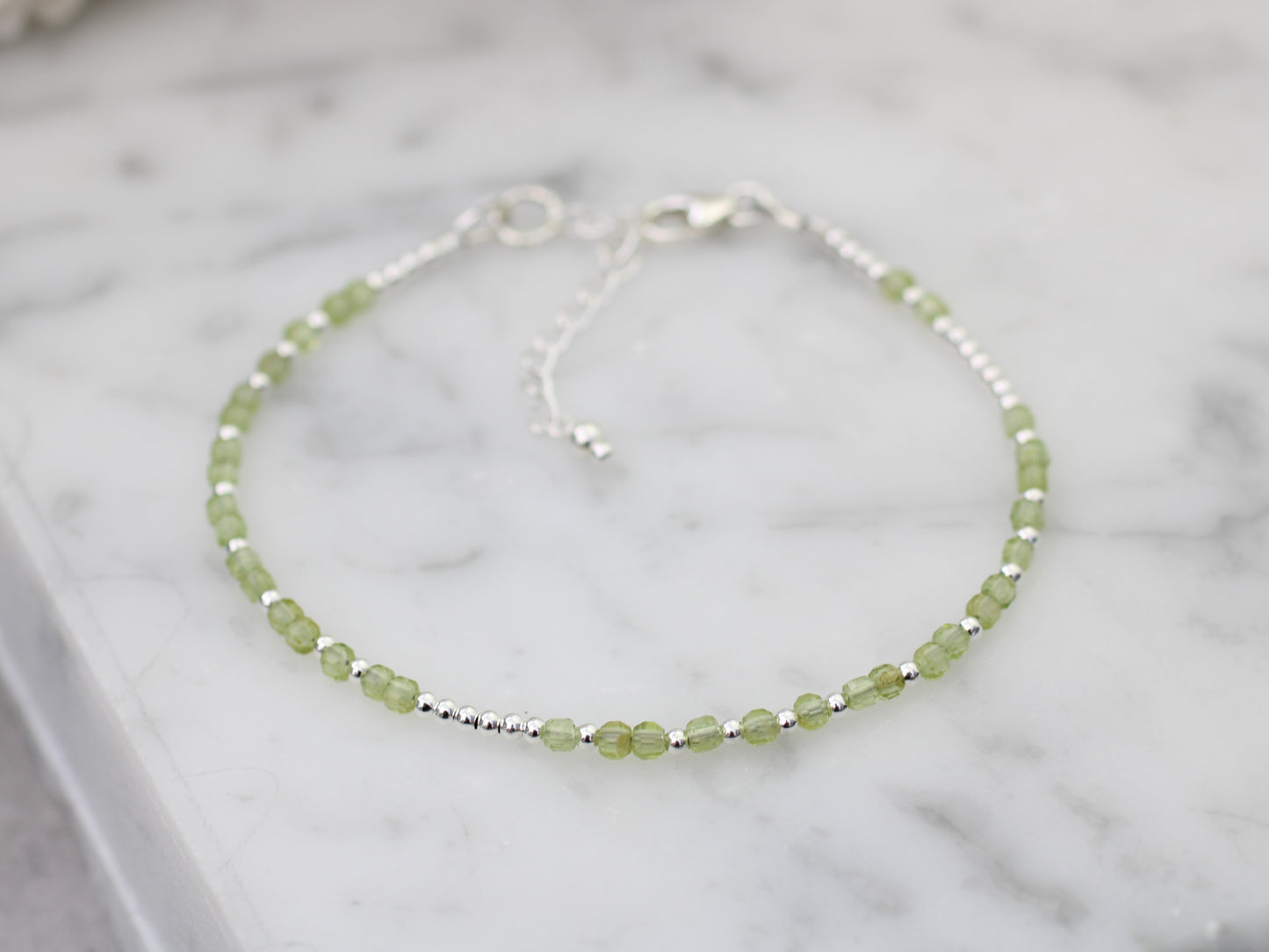 I love you morse code bracelet with peridot gemstones.