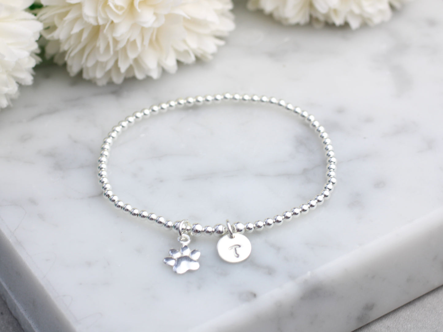 Personalised sterling silver paw print bracelet. Pet remembrance gift.