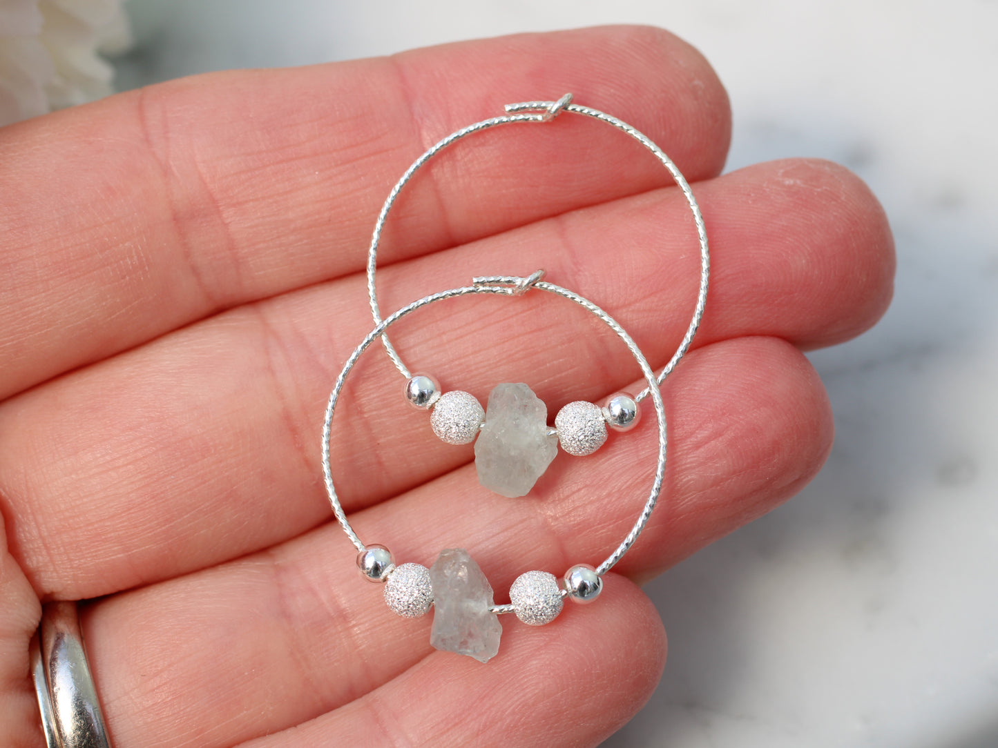 Raw aquamarine hoop earrings in sterling silver.