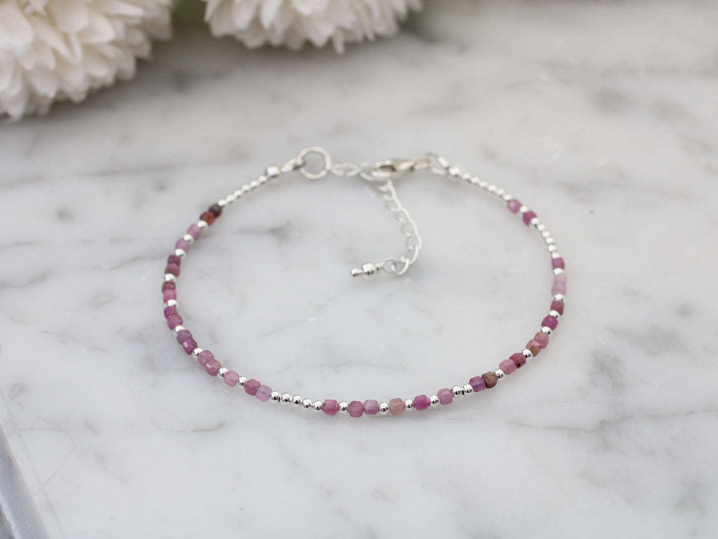 I love you morse code bracelet with ruby gemstones.
