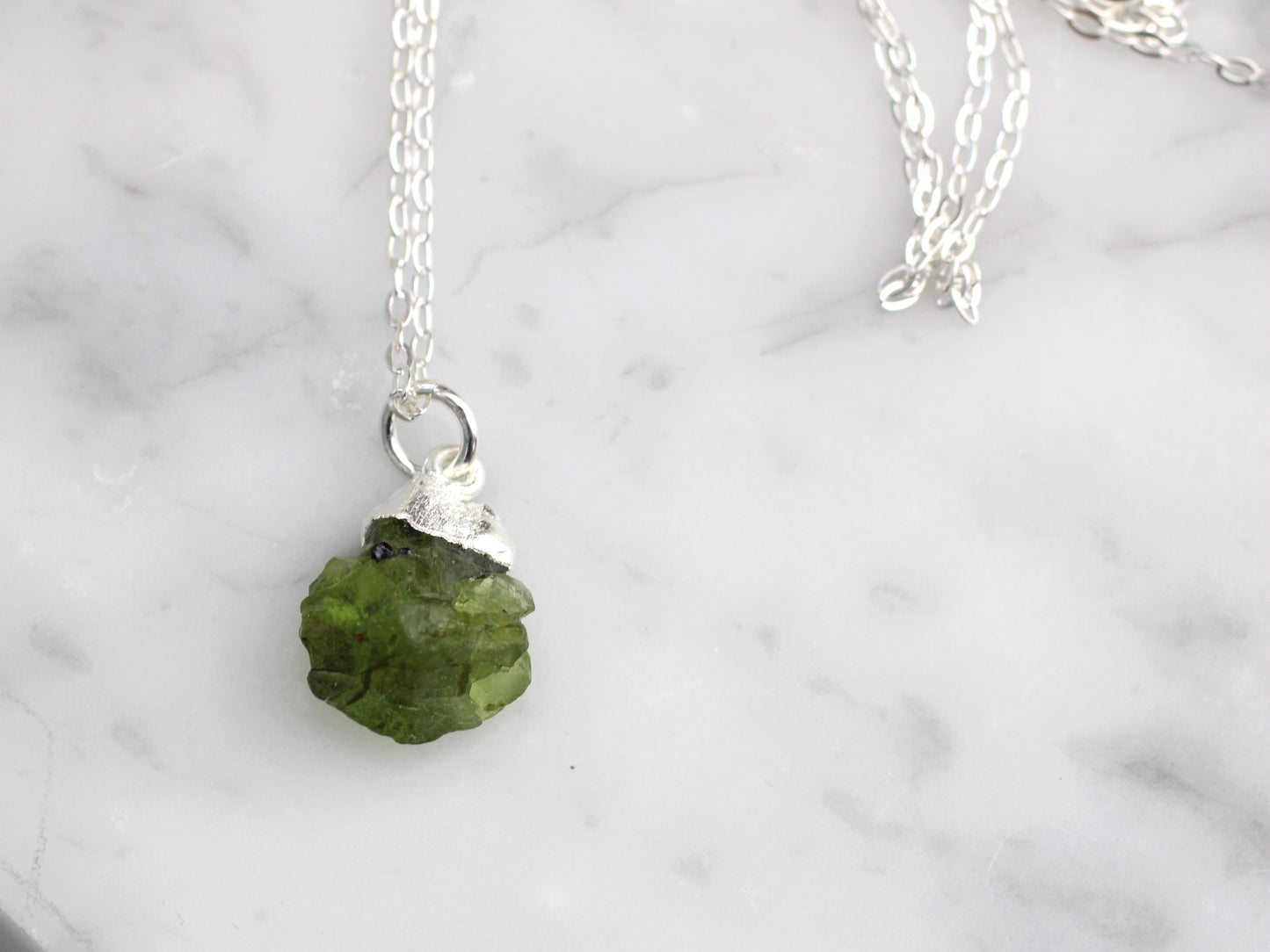 Raw peridot necklace in silver. August birthstone.