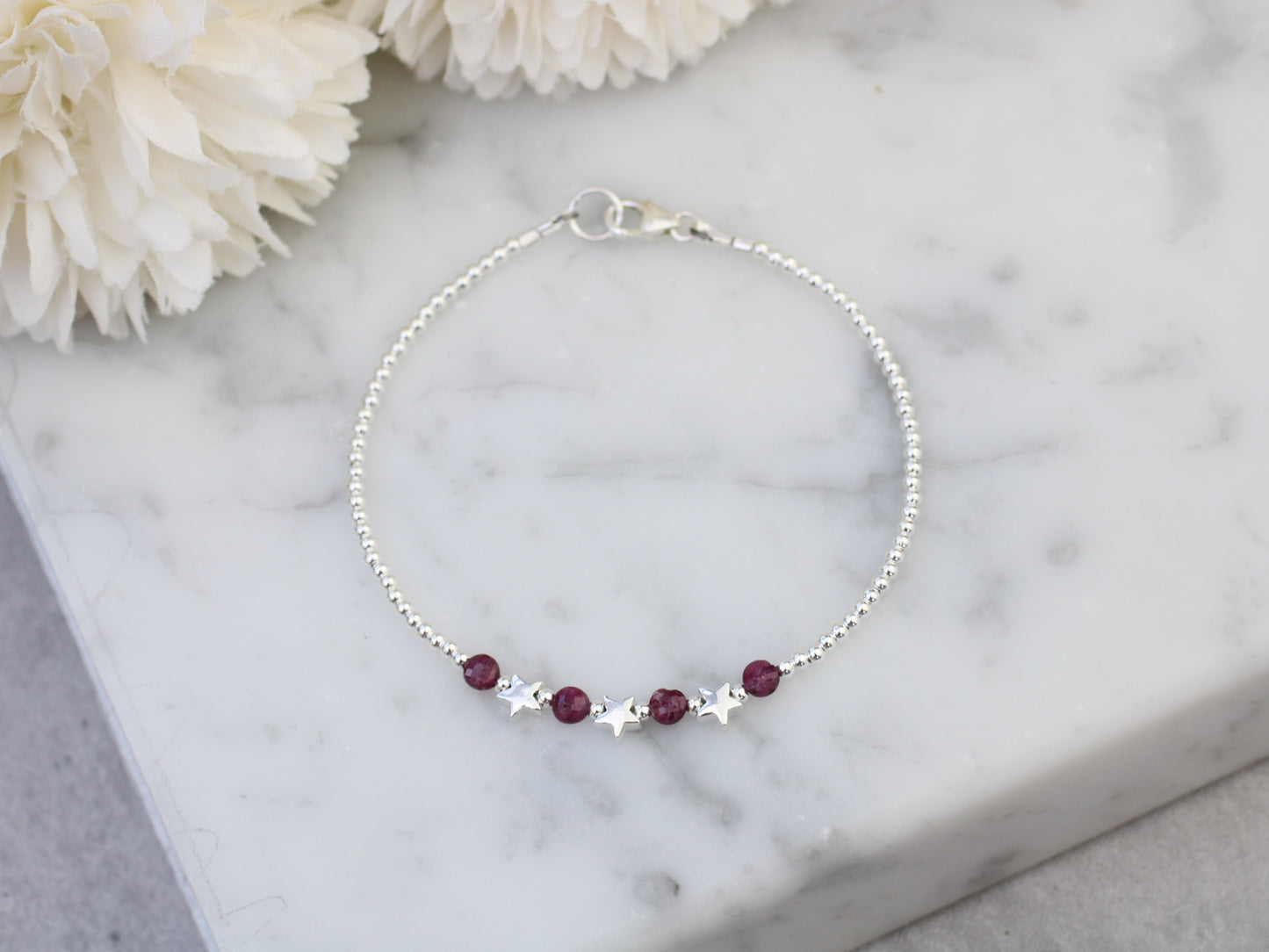 Star bracelet with ruby gemstones. July birthstone.