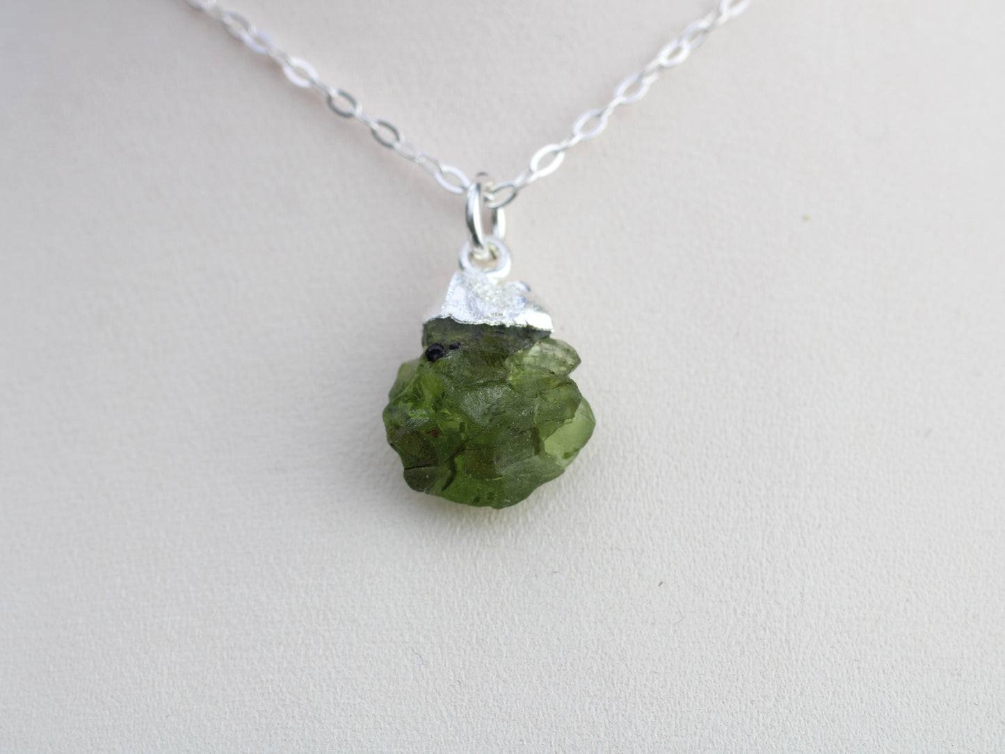 Raw peridot necklace in silver. August birthstone.