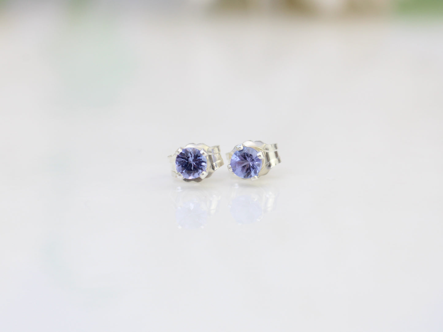 Tanzanite stud earrings in sterling silver or gold.