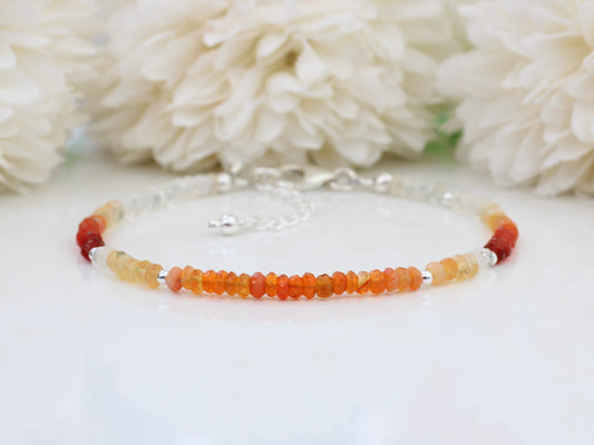 Fire opal bracelet in sterling silver with optional personalised initial tag. October birthstone bracelet.