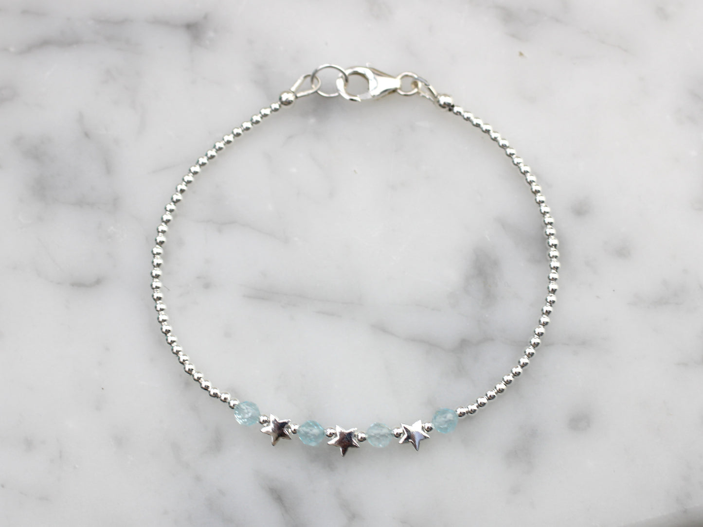 Star bracelet with blue topaz gemstones.