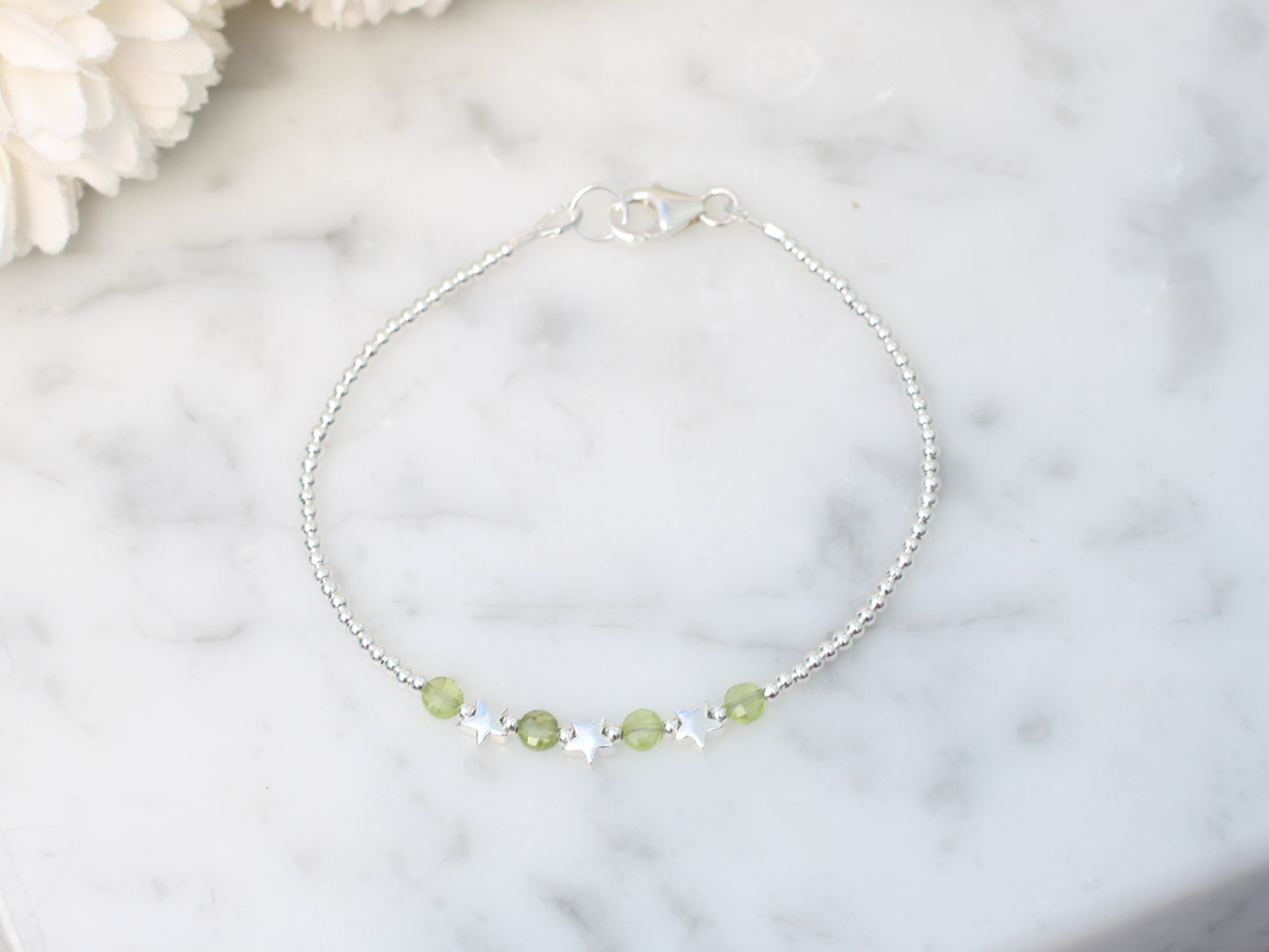 Star bracelet with peridot gemstones. August birthstone.