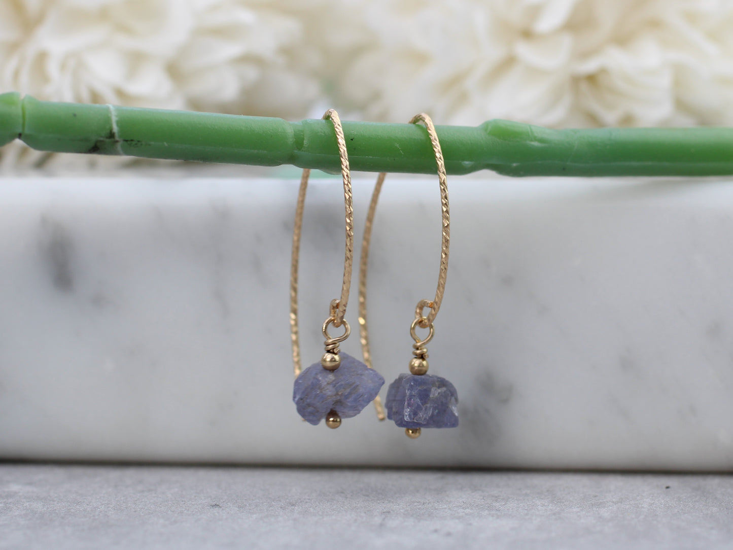 Raw tanzanite earrings in gold.