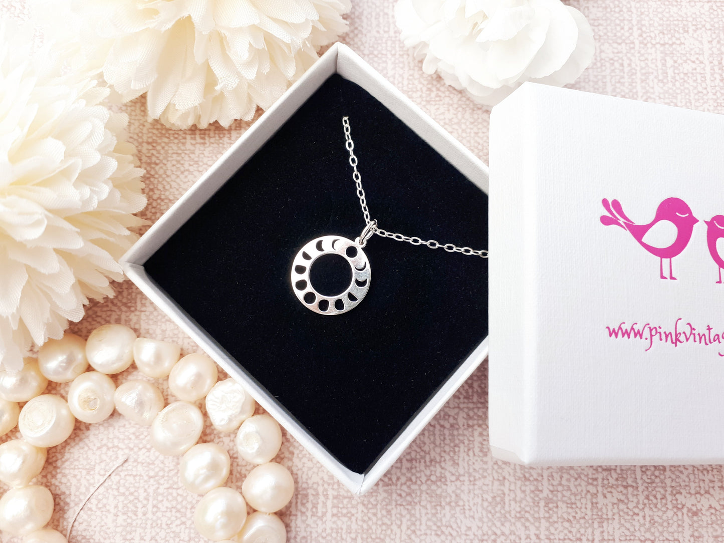 Moon phase necklace in sterling silver.