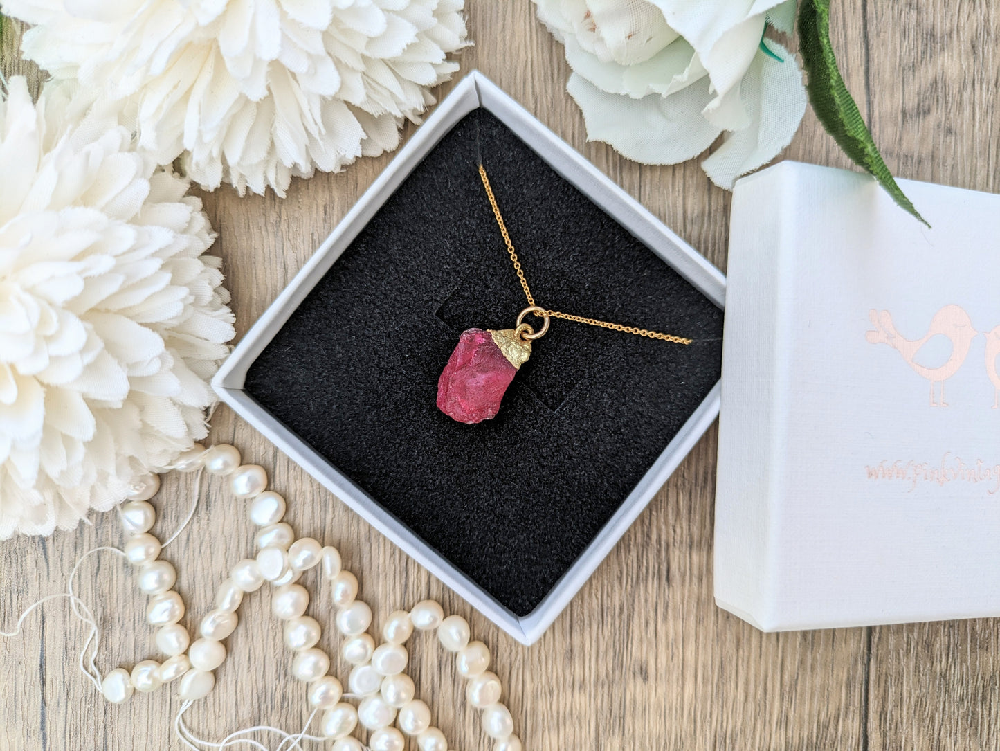 Raw ruby necklace in gold.