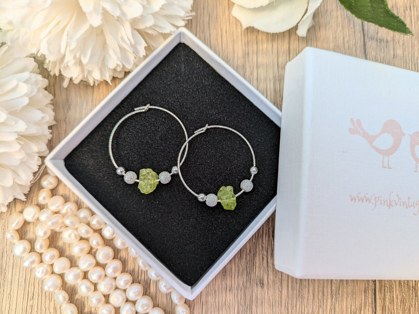 Peridot hoop earrings in silver.