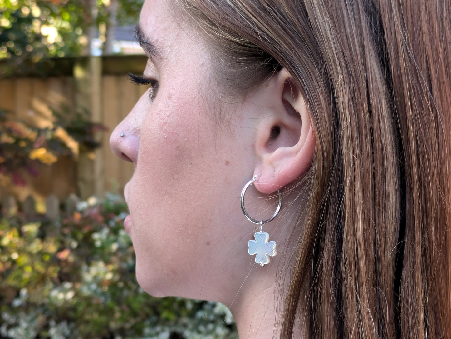 Four leaf clover hoop earrings in silver.