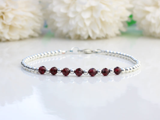 Garnet milestone bracelet in sterling silver.