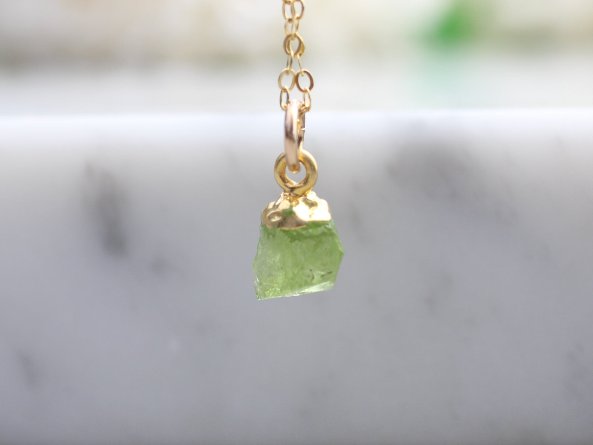 raw peridot necklace in gold