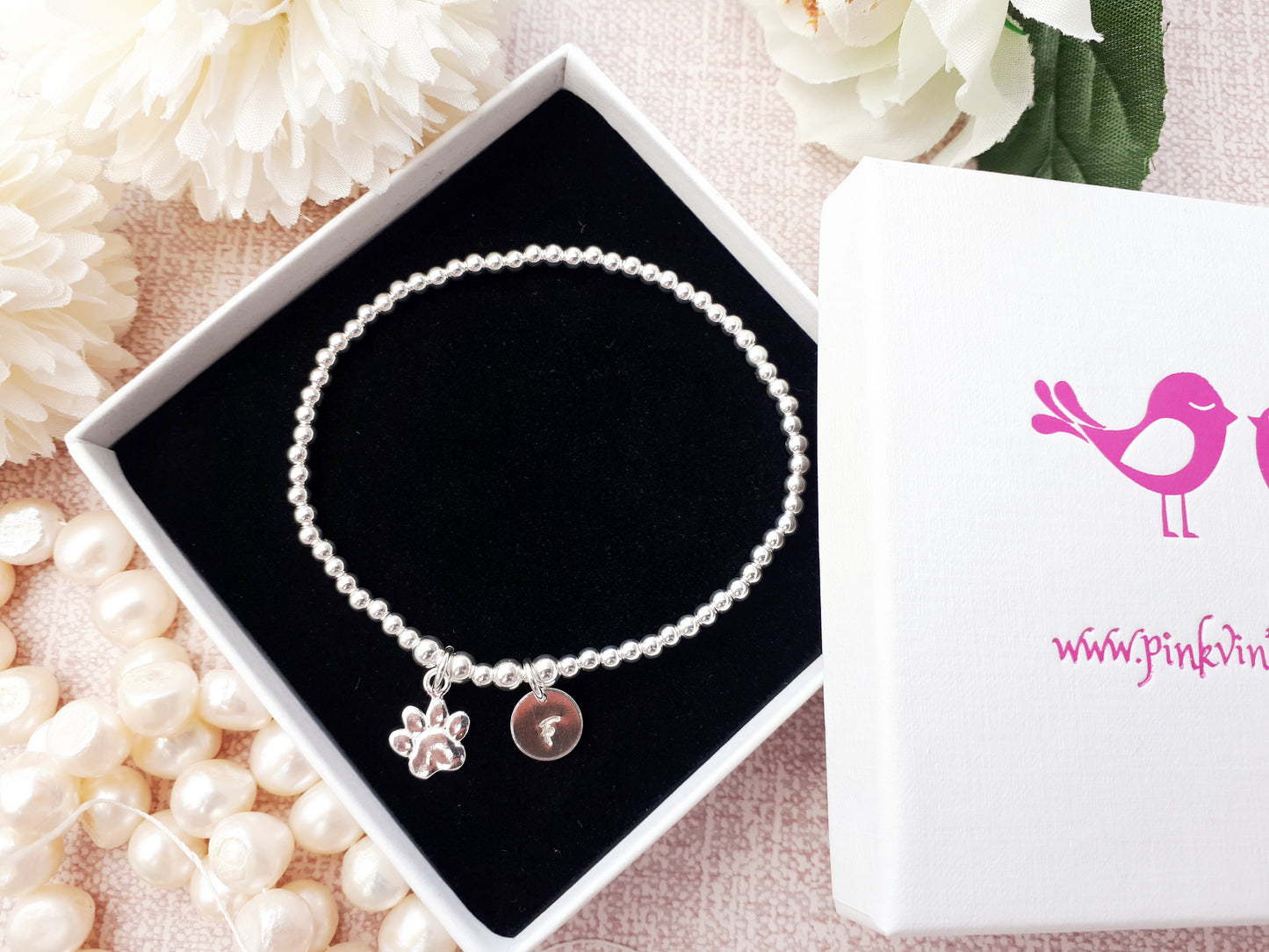 Personalised sterling silver paw print bracelet. Pet remembrance gift.