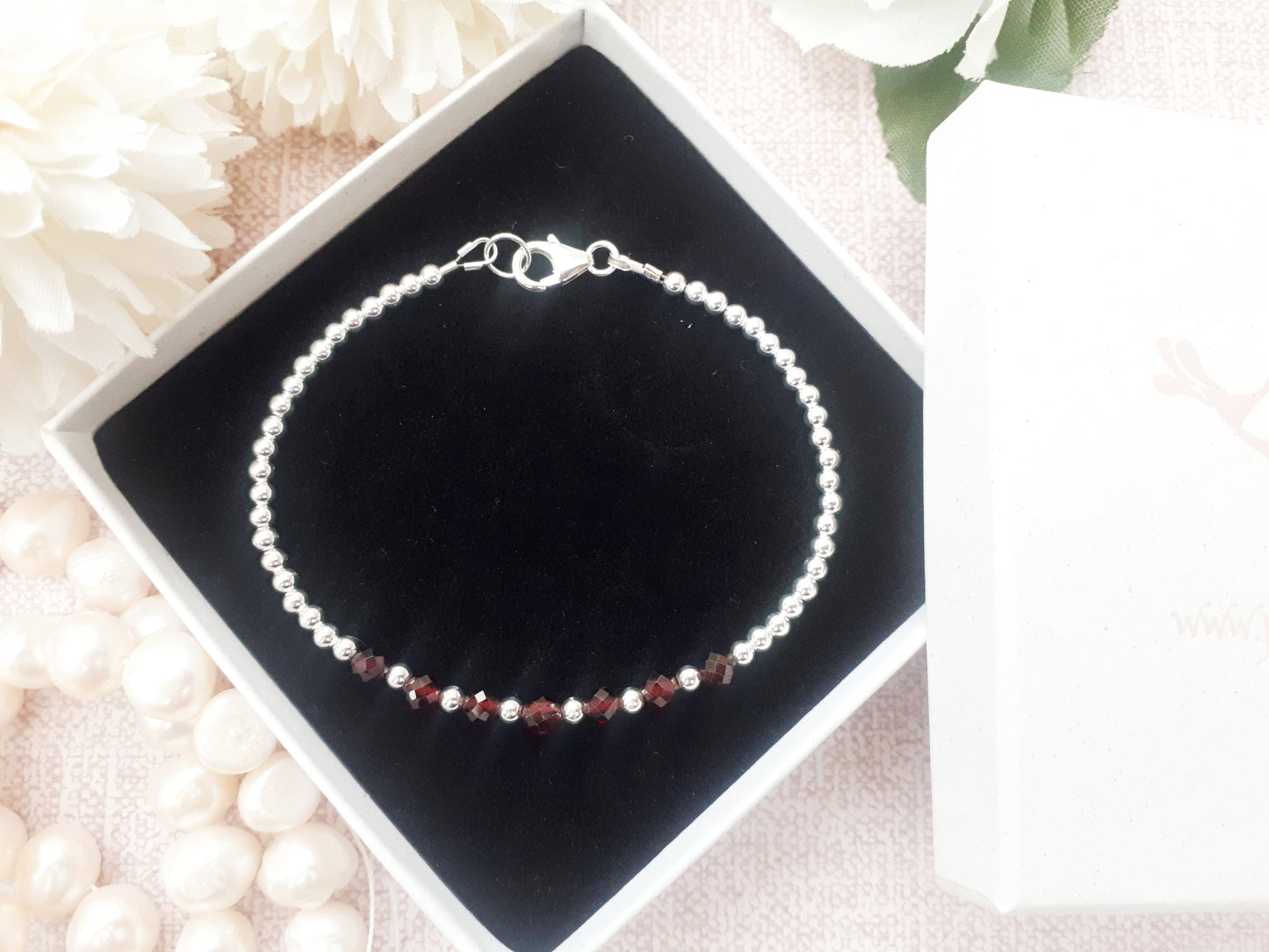 Garnet milestone bracelet in sterling silver.